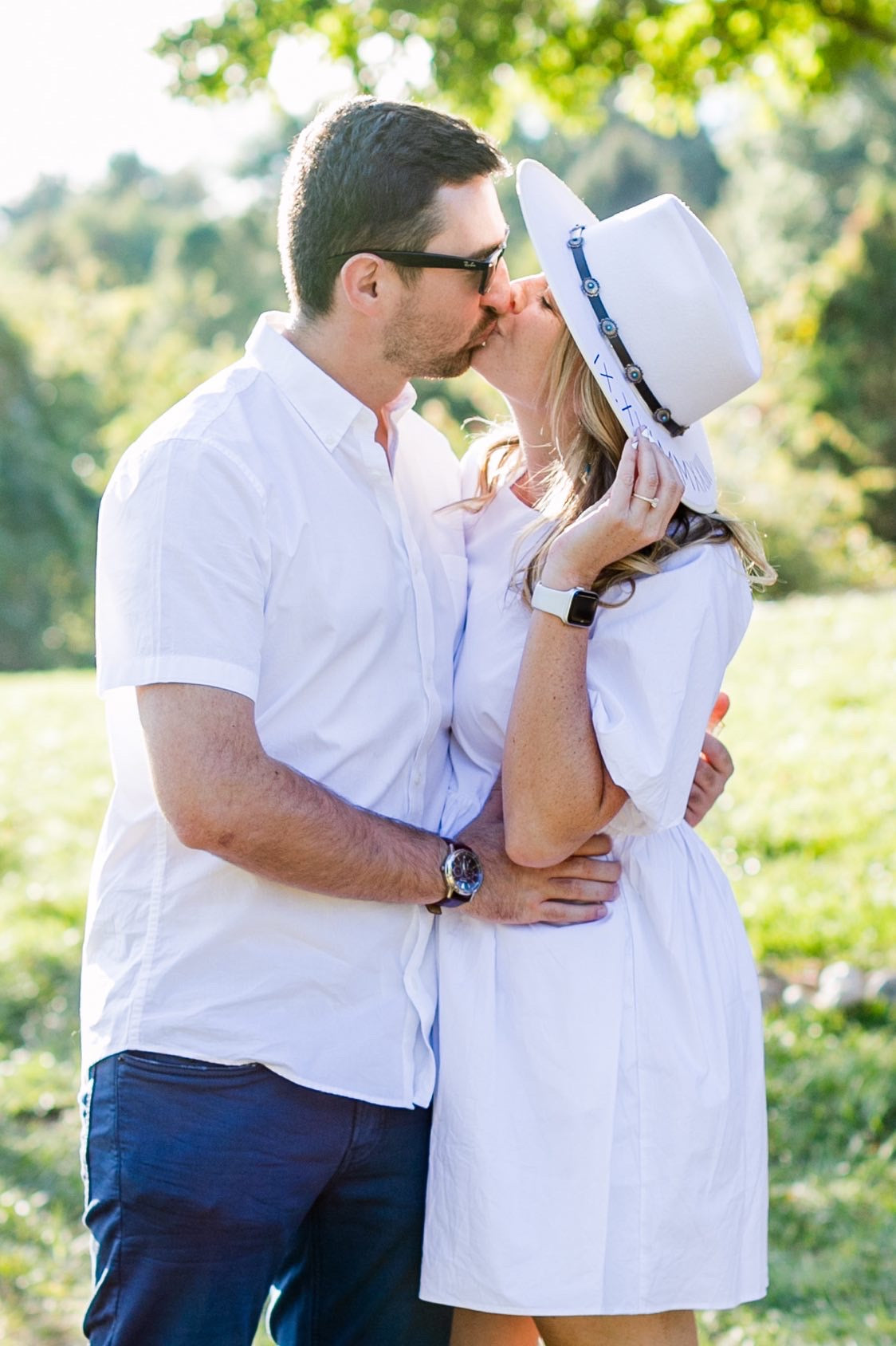 bride to be with future husband wearing personalized hat
