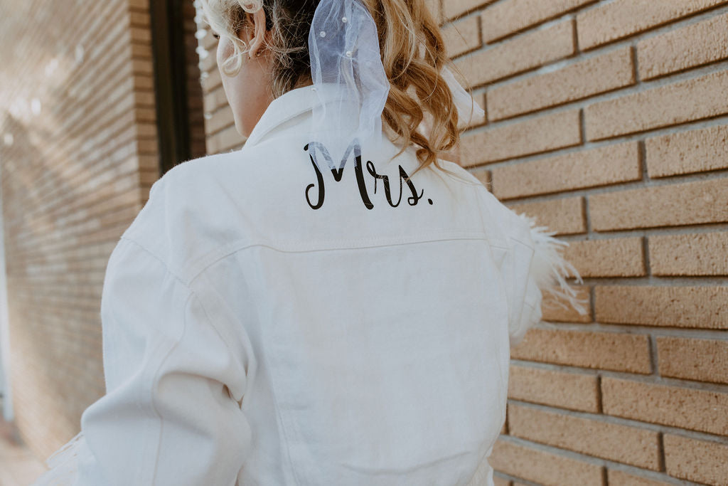 White cropped feather jacket with Mrs. personalized on the back with vinyl.