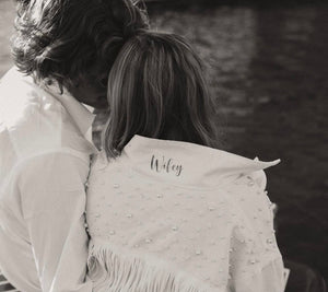 Closeup of pearl and fringe bride jean jacket with Wifey on the collar